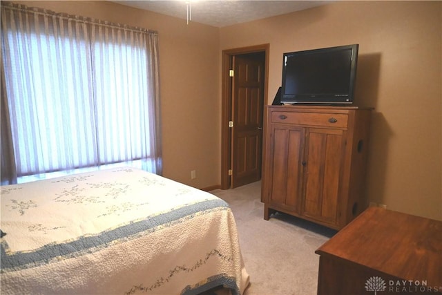 bedroom with light colored carpet