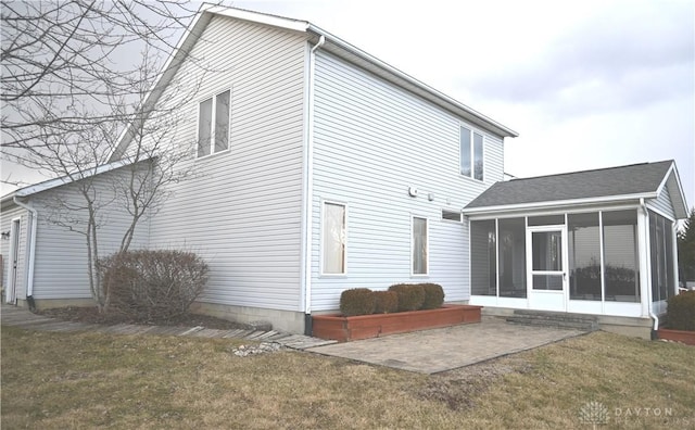 back of house with a sunroom, a patio, and a yard