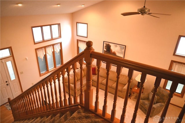 stairway featuring high vaulted ceiling