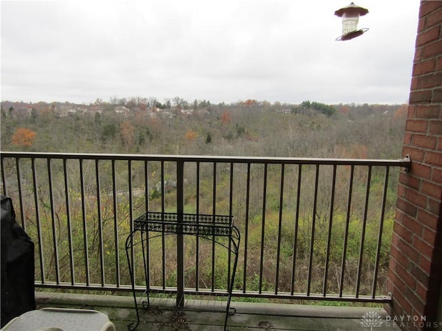 balcony featuring a view of trees