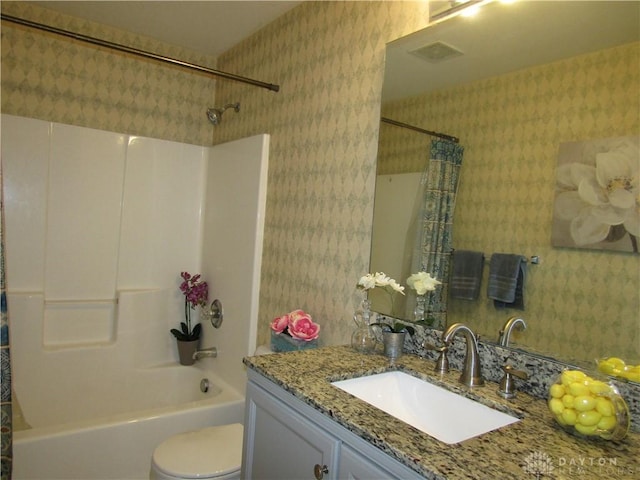 bathroom with toilet, wallpapered walls, shower / bath combo, and vanity