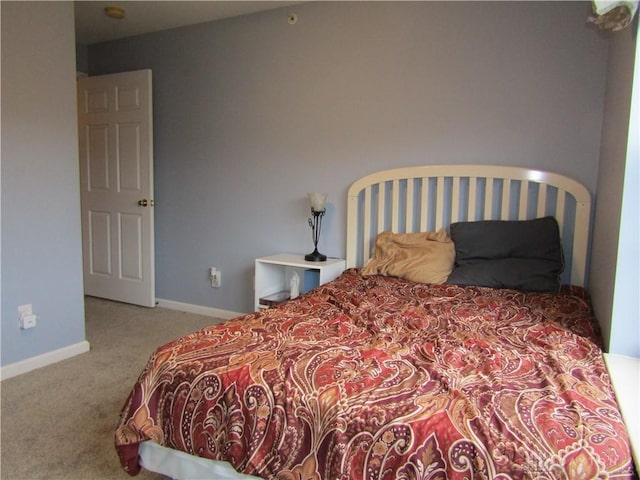 bedroom featuring carpet floors and baseboards