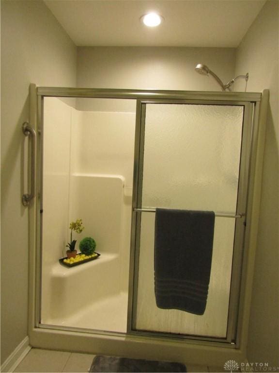 full bath featuring a stall shower, recessed lighting, and tile patterned floors