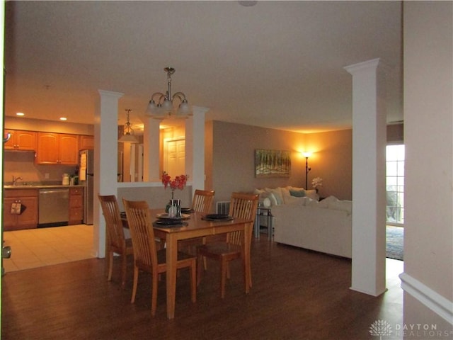 dining room featuring a chandelier, recessed lighting, decorative columns, and light wood-style flooring