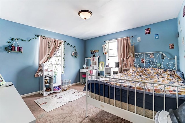 bedroom featuring carpet and baseboards