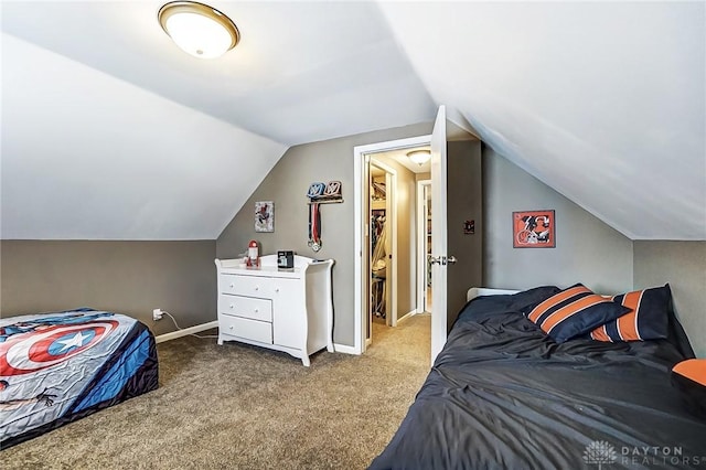 carpeted bedroom with baseboards and vaulted ceiling