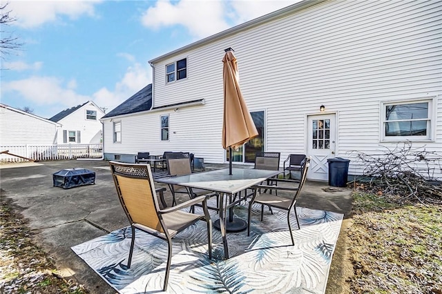 view of patio with outdoor dining area and fence