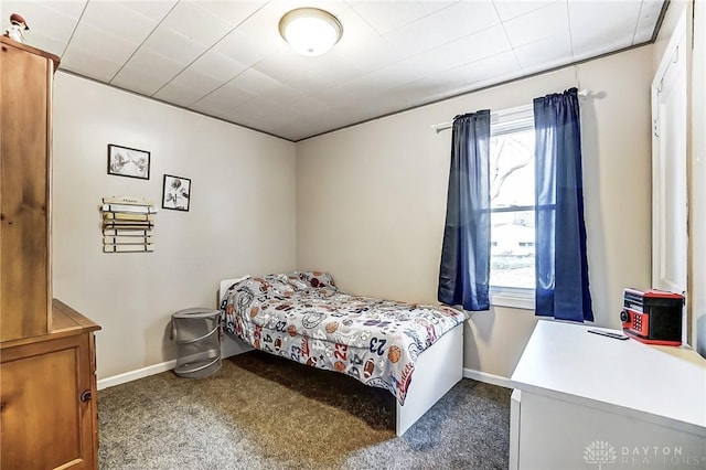 bedroom featuring carpet floors, multiple windows, and baseboards