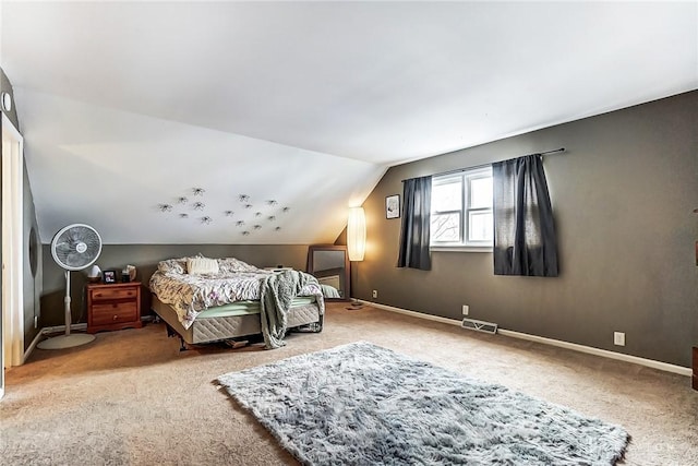 bedroom featuring baseboards, visible vents, vaulted ceiling, and carpet flooring