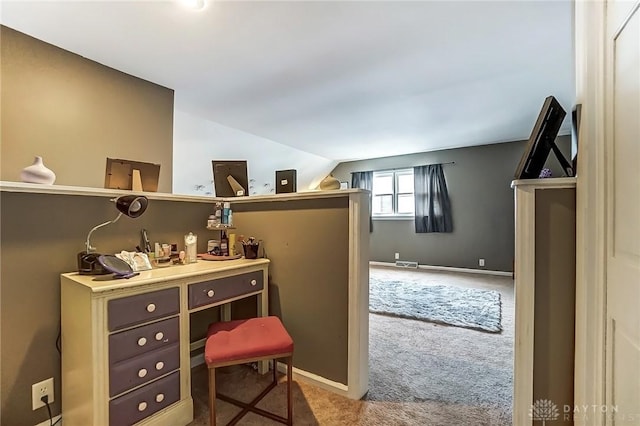 office space featuring vaulted ceiling, carpet, visible vents, and baseboards