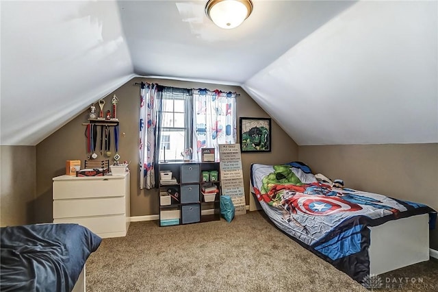 carpeted bedroom with lofted ceiling