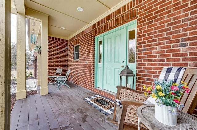 wooden terrace featuring covered porch