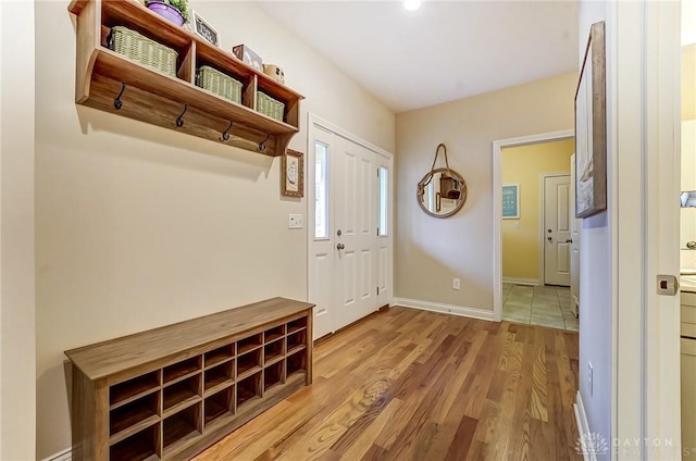 mudroom featuring baseboards and wood finished floors