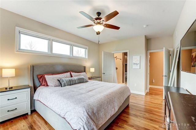 bedroom with baseboards, ceiling fan, and light wood-style floors