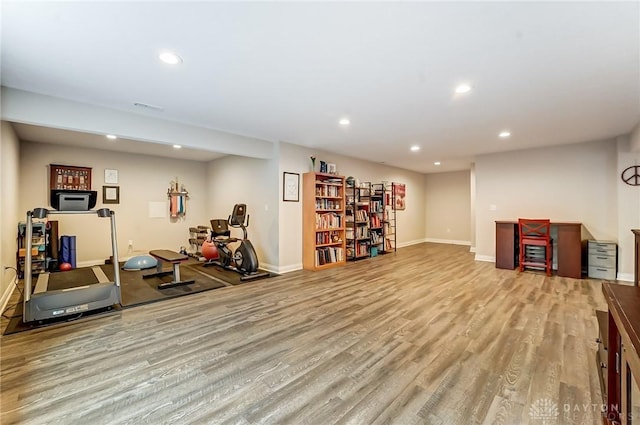 exercise area featuring baseboards, light wood finished floors, visible vents, and recessed lighting