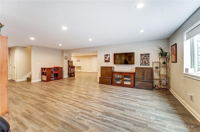 living area with stairs, recessed lighting, and wood finished floors