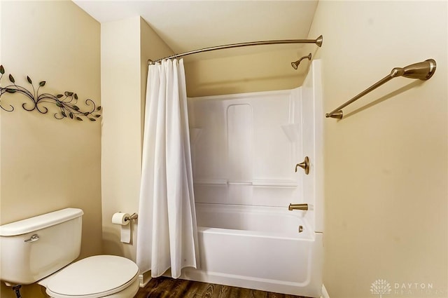 bathroom featuring shower / bath combo, wood finished floors, and toilet