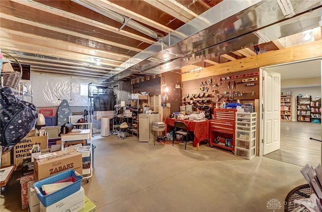 unfinished basement featuring a workshop area