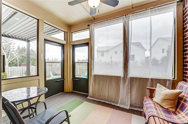 sunroom with a ceiling fan