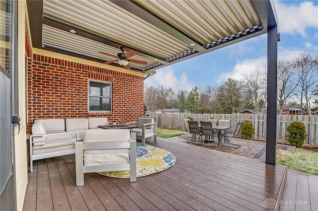 wooden deck featuring an outdoor living space, outdoor dining area, a fenced backyard, and a ceiling fan