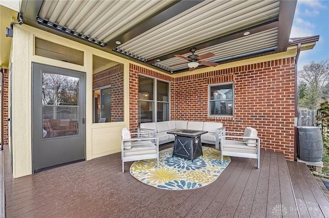 wooden terrace featuring outdoor lounge area and a ceiling fan