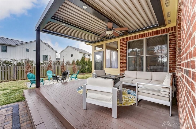 deck with outdoor lounge area, fence, and ceiling fan