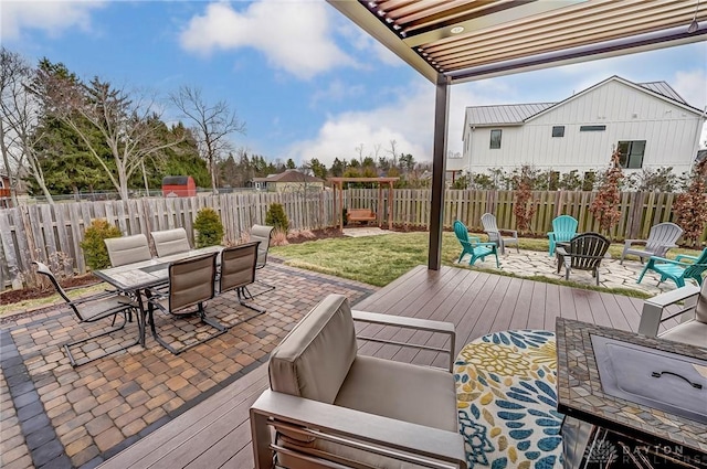 deck featuring a yard, a fenced backyard, outdoor dining area, and a patio