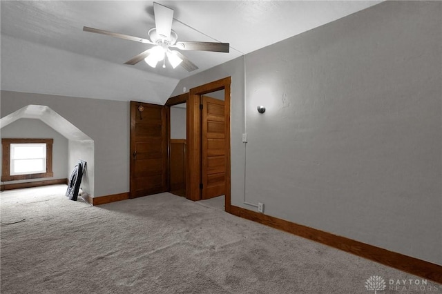 bonus room featuring lofted ceiling, carpet flooring, ceiling fan, and baseboards