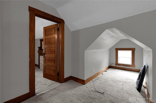 bonus room featuring carpet floors, vaulted ceiling, and baseboards