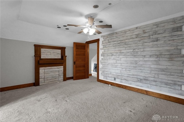 interior space with ceiling fan, baseboards, and carpet flooring