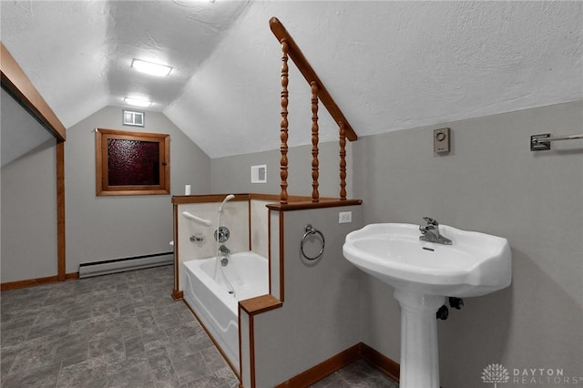 bathroom with a bath, visible vents, a baseboard heating unit, and a textured ceiling