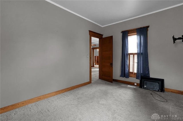 interior space with ornamental molding, carpet flooring, and baseboards