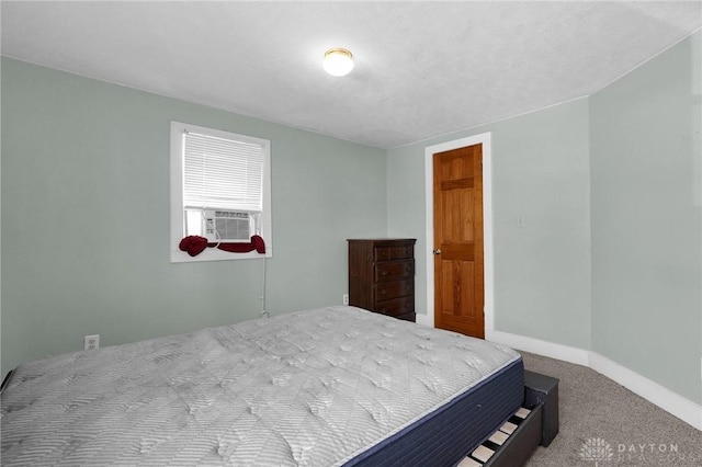 bedroom with carpet flooring and baseboards