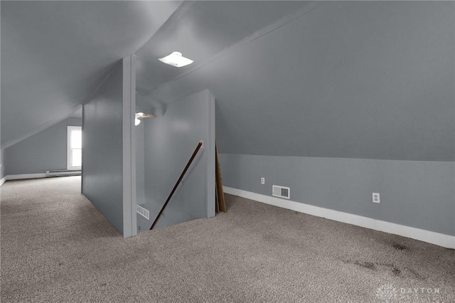 bonus room with carpet, lofted ceiling, a baseboard radiator, visible vents, and baseboards