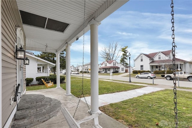 view of patio / terrace with a porch and a residential view