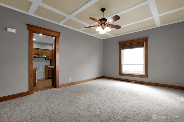 unfurnished room with light colored carpet, coffered ceiling, and baseboards