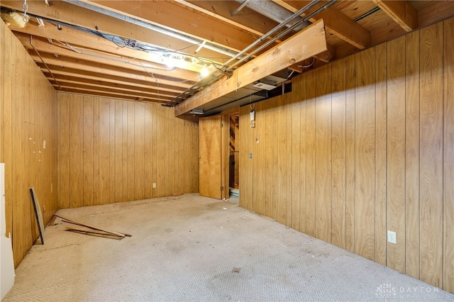 unfinished below grade area featuring wooden walls