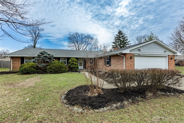 ranch-style home with a garage, a front yard, and brick siding