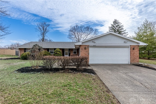 ranch-style home with a front yard, concrete driveway, and brick siding