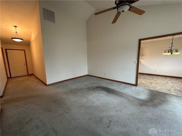 spare room with high vaulted ceiling, carpet, visible vents, and baseboards