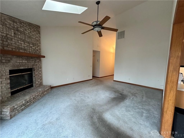 unfurnished living room featuring a brick fireplace, carpet, visible vents, and a ceiling fan