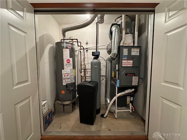 utility room featuring water heater