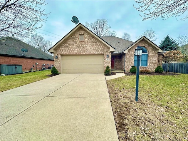 view of front of house featuring a garage, driveway, brick siding, and a front lawn