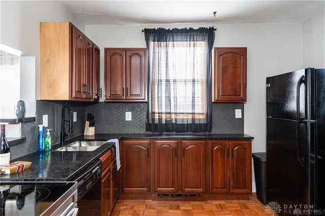 kitchen with tasteful backsplash, dark stone countertops, a sink, and black appliances