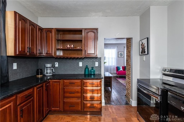 kitchen with black dishwasher, open shelves, decorative backsplash, stainless steel range with electric cooktop, and a textured ceiling