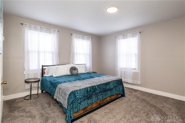 carpeted bedroom featuring baseboards