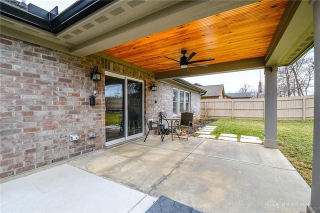 view of patio with a ceiling fan and fence