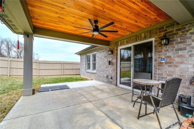 view of patio featuring ceiling fan and fence