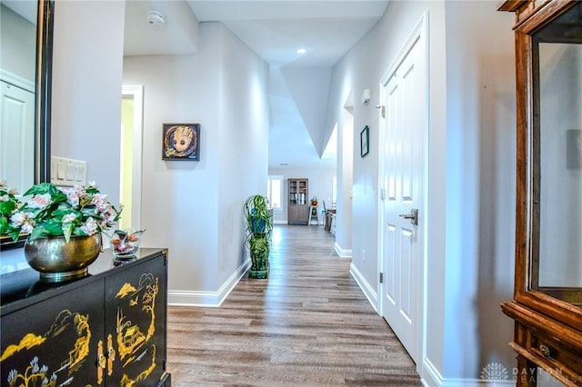 hall with wood finished floors and baseboards