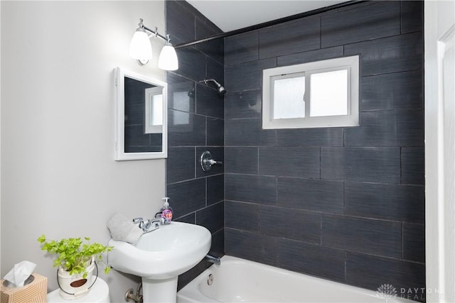 bathroom featuring a sink and shower / bathtub combination